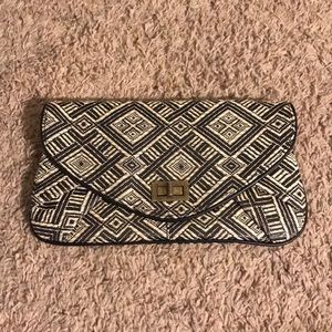 Tan & black woven clutch